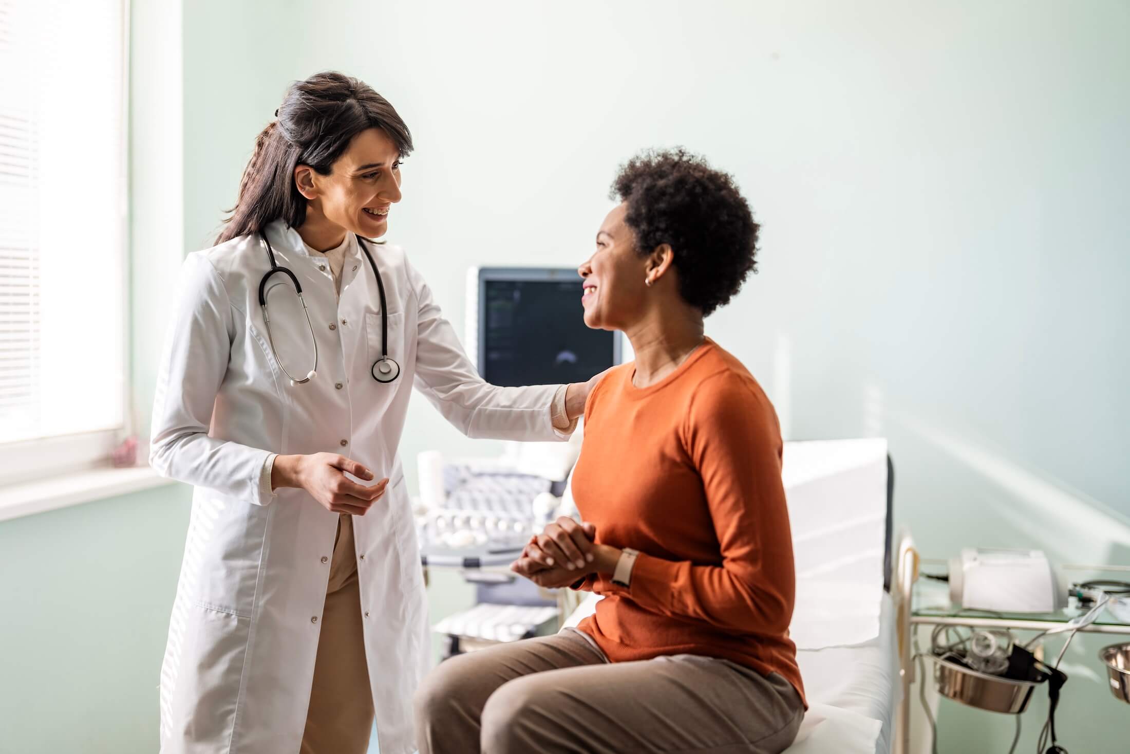 A patient talking to a clinician about endovascular deep brain stimulation technologies.